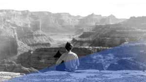 Photo of a Girl and Dog Looking Over a Canyon