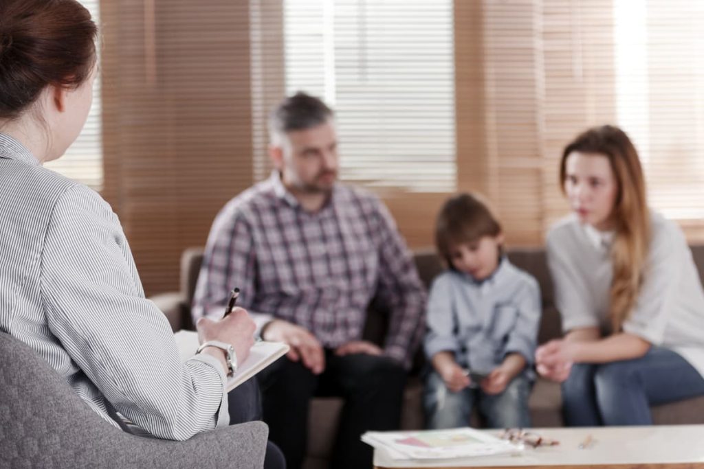 A family of 3 during a family based mental health service appointment.